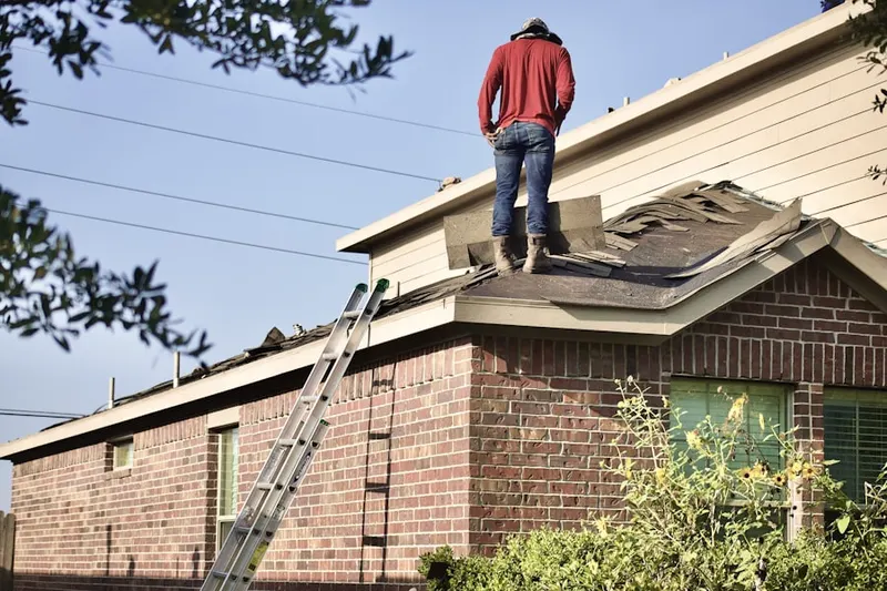 Professional roofer working on a residential roof in Hebron